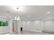 Open living room with gray wood-look flooring, recessed lighting, and a modern light fixture, perfect for entertaining at 12 Dunwoody Springs Dr # 12, Atlanta, GA 30328