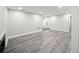 Spacious living room featuring modern wood flooring and neutral walls, complemented by recessed lighting and natural light at 12 Dunwoody Springs Dr # 12, Atlanta, GA 30328
