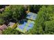 Aerial view of tennis courts surrounded by lush trees, for recreational activities at 12 Dunwoody Springs Dr # 12, Atlanta, GA 30328