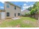 Grassy backyard featuring a concrete patio, lawn, and privacy fence at 150 Alton Cir, Villa Rica, GA 30180