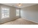 Bright bedroom featuring neutral walls, carpeted floor, and a ceiling fan at 150 Alton Cir, Villa Rica, GA 30180