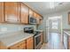 Kitchen featuring stainless appliances, tile floor, and wooden cabinets at 150 Alton Cir, Villa Rica, GA 30180