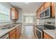Modern kitchen featuring wooden cabinets, stainless steel appliances, and tiled floors at 150 Alton Cir, Villa Rica, GA 30180