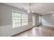 Bright living room featuring wainscoting, a light fixture, and access to the backyard at 150 Alton Cir, Villa Rica, GA 30180