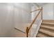 Carpeted staircase with wood railings and access to upstairs rooms at 150 Alton Cir, Villa Rica, GA 30180