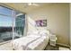 Bright bedroom with city views from large windows and a modern ceiling fan at 250 Pharr Ne Rd # 1112, Atlanta, GA 30305