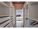 Spacious walk-in closet with built-in shelving and drawers adjacent to a bedroom at 250 Pharr Ne Rd # 1112, Atlanta, GA 30305