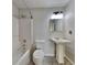 Bathroom featuring a shower/tub combo, pedestal sink, and tile flooring at 4706 Derby Loop, Fairburn, GA 30213