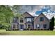 Elegant brick home featuring a lush lawn, beautiful windows and blue shutters at 4706 Derby Loop, Fairburn, GA 30213