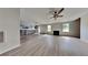 Open-concept living room with fireplace, stainless steel appliances, and gray vinyl flooring at 4706 Derby Loop, Fairburn, GA 30213