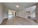 Spacious living room features modern gray vinyl flooring, natural light, and staircase at 4706 Derby Loop, Fairburn, GA 30213