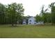 Spacious backyard view with a large white house and expansive lawn at 8 Ripplewood Trl, Euharlee, GA 30145