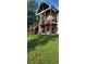Spacious backyard with a multi-level deck featuring outdoor fireplace and covered patio at 8 Ripplewood Trl, Euharlee, GA 30145