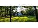 Lush backyard featuring mature trees, manicured lawn, and partial view of home at 8 Ripplewood Trl, Euharlee, GA 30145