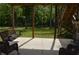 A covered backyard patio overlooks a large, tree-lined lawn at 8 Ripplewood Trl, Euharlee, GA 30145
