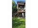 Multi-level deck offers outdoor fireplace, covered patio, and backyard views at 8 Ripplewood Trl, Euharlee, GA 30145