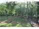 Grassy backyard with many mature trees at 8 Ripplewood Trl, Euharlee, GA 30145