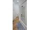 Bathroom with tiled shower and tub combination, toilet, blue rug and hard wood floors at 8 Ripplewood Trl, Euharlee, GA 30145