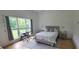 Bright bedroom with large window, grey rug, desk and chair and a full bed with two night stands at 8 Ripplewood Trl, Euharlee, GA 30145