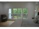 Light-filled bedroom featuring a wall of windows overlooking the backyard, hardwood floors and pendant lighting at 8 Ripplewood Trl, Euharlee, GA 30145