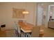 Elegant dining room with decorative chandelier, map, light wood table and seating for six at 8 Ripplewood Trl, Euharlee, GA 30145