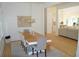 Bright dining room boasts a light wood floor and view into living room at 8 Ripplewood Trl, Euharlee, GA 30145