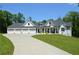 Charming home featuring a three-car garage, manicured lawn, and long driveway at 8 Ripplewood Trl, Euharlee, GA 30145