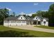 Charming home featuring a three-car garage, manicured lawn, and long driveway at 8 Ripplewood Trl, Euharlee, GA 30145