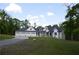 Charming home featuring a three-car garage, manicured lawn, and long driveway at 8 Ripplewood Trl, Euharlee, GA 30145