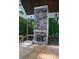 Outdoor fireplace made of stone and wood, with a wooden deck and forest in the background at 8 Ripplewood Trl, Euharlee, GA 30145