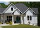 Inviting front entrance with double doors, columns, seating and meticulous landscaping at 8 Ripplewood Trl, Euharlee, GA 30145