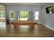 Game room with large doors to the backyard, pool table, and a mounted television at 8 Ripplewood Trl, Euharlee, GA 30145