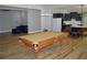Spacious game room with a pool table and open layout to the kitchen and living area at 8 Ripplewood Trl, Euharlee, GA 30145