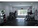 Well-equipped home gym with various exercise machines, weights, and mirrored wall at 8 Ripplewood Trl, Euharlee, GA 30145