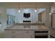 Modern kitchen with stainless steel appliances and a stone countertop island overlooks the living room at 8 Ripplewood Trl, Euharlee, GA 30145