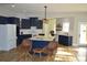 Open-concept kitchen with a large island, blue cabinets, and modern lighting, perfect for entertaining at 8 Ripplewood Trl, Euharlee, GA 30145