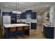 Beautiful kitchen with blue cabinets, modern lighting, and center island with seating at 8 Ripplewood Trl, Euharlee, GA 30145