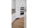 Stylish kitchen cabinets with stainless steel handles, built-in oven, and hardwood floors at 8 Ripplewood Trl, Euharlee, GA 30145