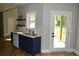 Cozy kitchen area featuring navy blue cabinets, white countertop, open shelves, and stainless steel appliances at 8 Ripplewood Trl, Euharlee, GA 30145