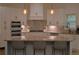 Bright kitchen boasts white cabinets, stainless steel appliances, and a marble backsplash at 8 Ripplewood Trl, Euharlee, GA 30145