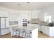 Modern kitchen features white cabinets, an island with seating, and stainless steel appliances at 8 Ripplewood Trl, Euharlee, GA 30145