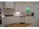 An elegant kitchen with stainless appliances, stone countertops, and a window at 8 Ripplewood Trl, Euharlee, GA 30145