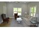 Bright living room featuring a grey rug with a sofa, end tables and two chairs with a window at 8 Ripplewood Trl, Euharlee, GA 30145