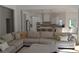 Open concept living room with hardwood floors, large sectional, and view into kitchen at 8 Ripplewood Trl, Euharlee, GA 30145