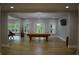 Inviting living room with pool table, natural light, and modern decor at 8 Ripplewood Trl, Euharlee, GA 30145