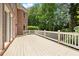 Spacious wooden deck with brick home exterior and railing overlooking backyard at 1200 Bay Pointe Terr Ter, Alpharetta, GA 30005