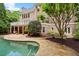 A serene backyard pool features stone decking and landscaping, complemented by a spacious balcony at 1200 Bay Pointe Terr Ter, Alpharetta, GA 30005