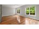 Spacious bedroom with hardwood floors and large windows overlooking trees at 1200 Bay Pointe Terr Ter, Alpharetta, GA 30005
