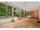 Charming covered patio with stone flooring and view of the pool and greenery at 1200 Bay Pointe Terr Ter, Alpharetta, GA 30005
