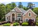 Stately brick home featuring manicured landscaping, arched windows, and a welcoming entrance at 1200 Bay Pointe Terr Ter, Alpharetta, GA 30005